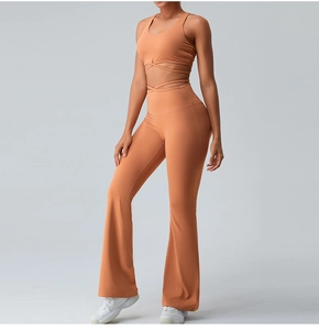 Detail of orange yoga top with racerback design and crossed waist straps for support
