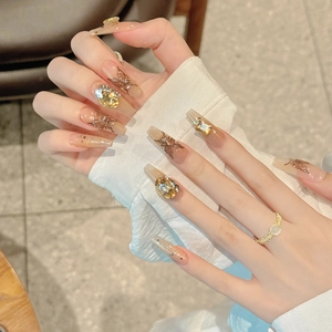 Brown butterfly press-on nails with amber gemstones and glitter in long coffin shape