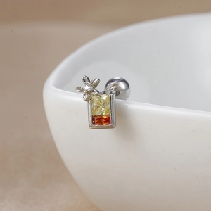 Macro view of cocktail glass stud earring with yellow and orange cubic zirconia stones