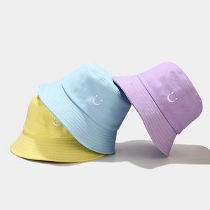 Unisex canvas bucket hats with minimalist smile embroidery in yellow, blue and purple