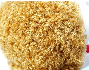 Close-up of soft yellow-brown plush material and textured fabric of the family hand puppet