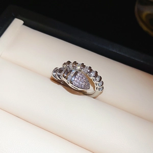 Macro shot of silver snake ring with baguette-cut stones and pavé cubic zirconia