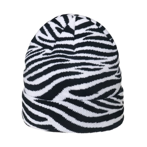 Close-up of black and white zebra pattern knit beanie with soft wool texture