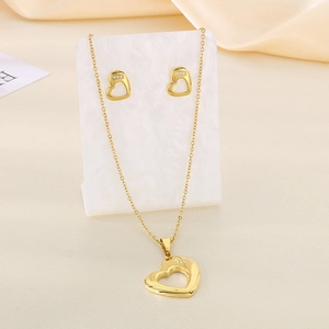 Detailed close-up of hollow heart jewelry set with necklace and earrings on stand