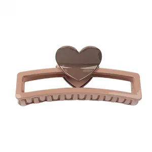 Detail of a brown heart accent on a rectangular hair claw clip for thick hair