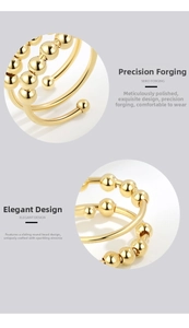 Macro detail of adjustable gold fidget ring featuring sliding beads and zircon inlay