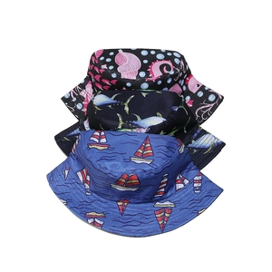 Three stacked bucket hats with seahorse, fish, and sailboat patterns for beach sun protection