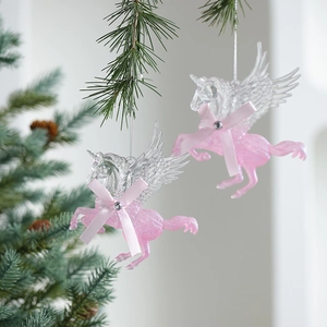 Pink glitter unicorn Christmas tree ornament with transparent wings on pine branch