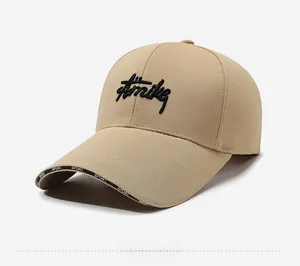 Detail shot of khaki baseball cap with black embroidered script and SPORT printed brim