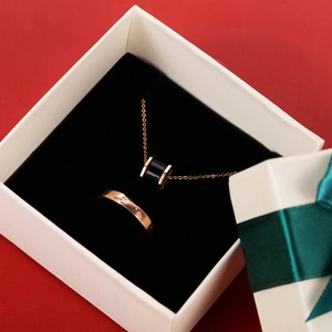 Rose gold necklace and diamond ring set in a premium white gift box with green ribbon