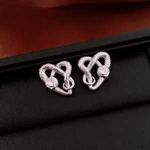 Intertwined heart stud earrings with snakeskin texture and sparkling zircon stones