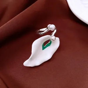 Calla lily enamel open ring with white pearls and green accents on silk fabric