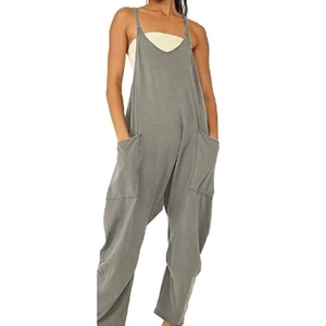 Detail view of grey sleeveless loose jumpsuit featuring a V-neckline and large side pockets