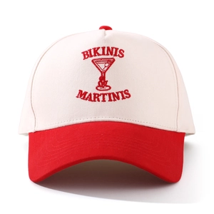 Detailed view of red and white baseball cap with red embroidered letters and texture