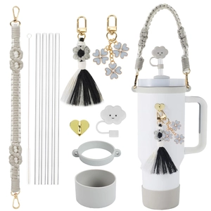 Set of water bottle accessories with beige strap, cloud cap and clover charms