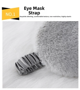 Close-up of elastic satin strap and soft faux fur on a plush gray sleep eye mask