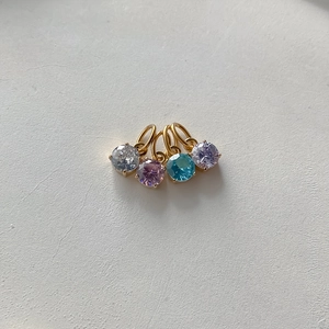 Detailed macro view of vibrant multi-colored round crystal charms with gold-plated jump rings