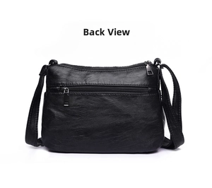 Rear view of black soft leather crossbody bag showing a functional zippered back pocket