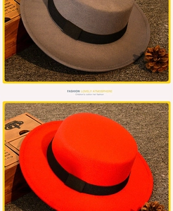 Detail of red and grey wool felt flat top hats for children with black ribbon bands