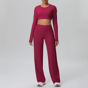 Detail view of pink long sleeve crop top and wide leg high waist yoga pants set for women