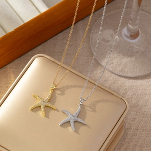 Detail of starfish pendants with cubic zirconia inlay in gold and silver finishes