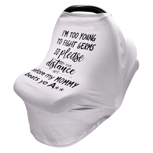 Close-up of nursing cover for car seats featuring black text on white stretch fabric