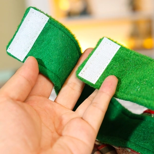 Macro view of the green felt fabric texture and hook-and-loop fastener closure detail