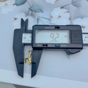 Detailed measurement of gold banana charm with zircon inlay showing a size of 9.2mm