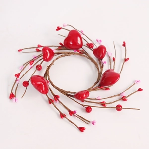Close-up of red and pink berries with red hearts on a branch candle ring for Valentines
