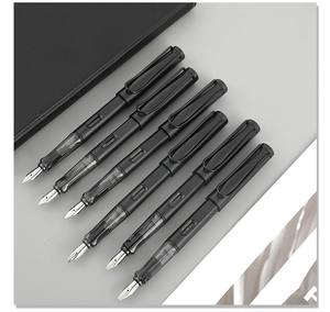 Detail of matte black gothic parallel pens with silver nibs on a professional desk