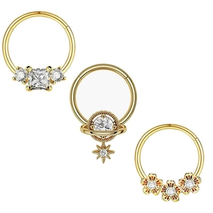 Three-piece gold nose ring set with cubic zirconia featuring flower, star, and square designs