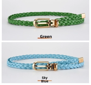 Close-up of green and sky blue braided belts with gold horseshoe buckles for women