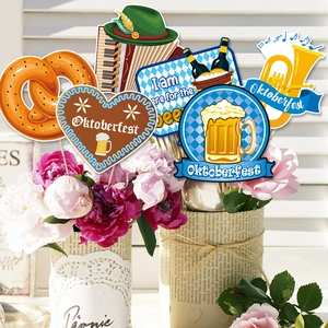 Oktoberfest party decoration kit with photo props in a floral vase on white background