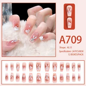 Detail of pink gradient press-on nails with 3D bunny and glitter heart designs