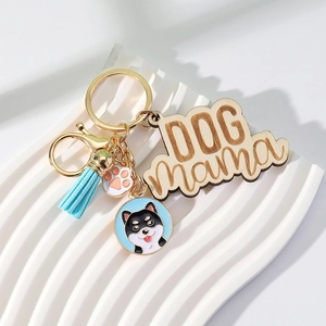 Detail of wooden Dog Mama keychain with Shiba Inu charm and blue silk tassel