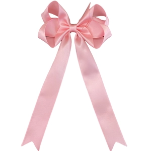 Detail of pink satin ribbon bow hair clip with long streamers and elegant fishtail ends
