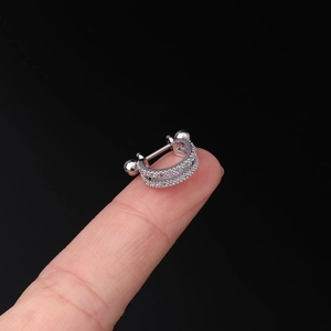 Macro shot of minimalist silver cartilage earring with double row cubic zirconia crystals
