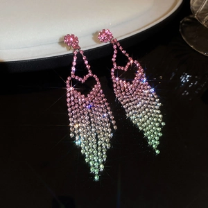 Macro shot of gradient fringe earrings featuring heart studs and sparkling rhinestones
