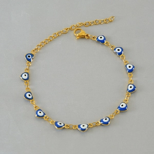 Detail of 18K gold-plated heart-shaped evil eye bracelet with blue enamel inlays