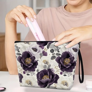 Floral makeup bag with purple flowers, black handle and zipper for travel organizing