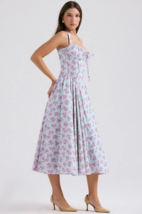 Detailed view of light blue floral summer dress with halter neck and ruffled trim