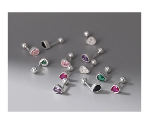 Macro shot of colorful pear-cut zircon stud earrings with silver screw back closures