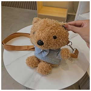 Detail of cute brown teddy bear plush crossbody bag featuring a grey hoodie and pearl bow