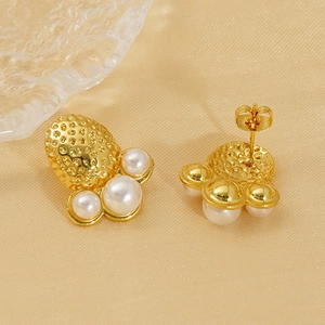 Hammered gold pearl earrings with three white pearls on champagne satin backdrop