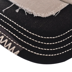 Macro detail of washed denim baseball cap brim with distressed edges and stitching