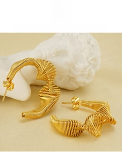 Macro shot of 18K gold-plated spiral earrings featuring eco-friendly lead-free material