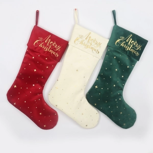 Three velvet Christmas stockings in red, cream, and green with golden embroidery