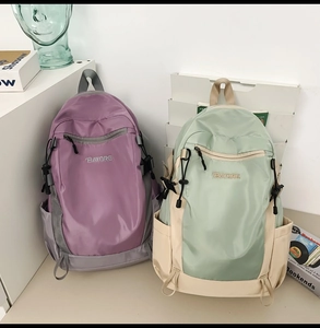 Close-up of purple and light green waterproof nylon backpacks with BAYORE embroidery