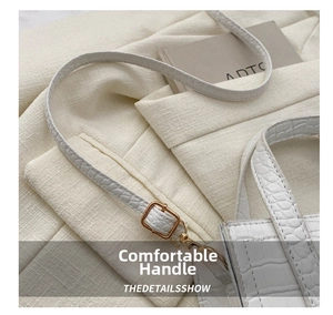 Detail of white crocodile pattern leather texture with golden metal buckles and strap