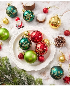 Detailed view of colorful Christmas balls with glitter patterns and shiny finishes on white tray